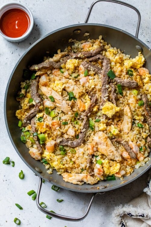 Fried Rice in a wok with sriracha
