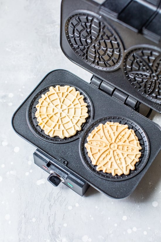 Pizzelle Cookies in a pizzelle press.