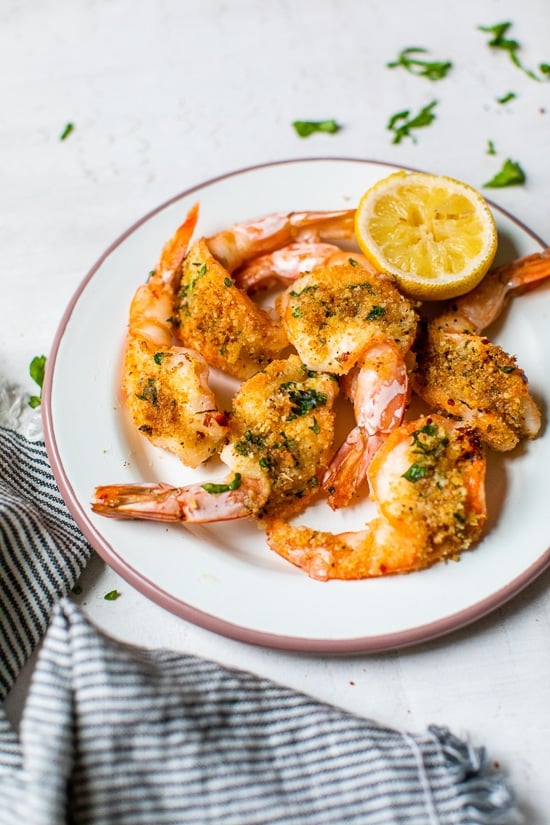 Shrimp Oreganata on a plate with lemon
