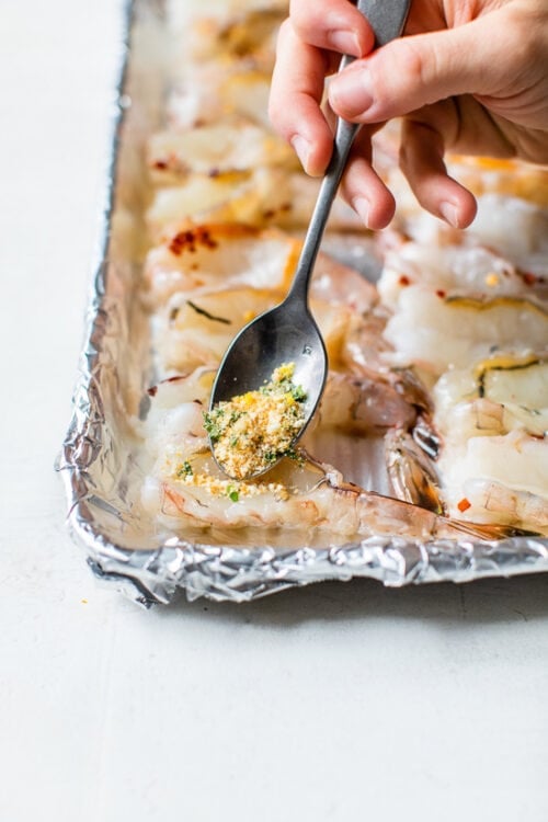 Spooning crumbs on shrimp