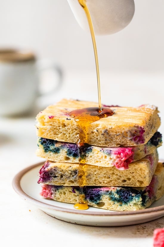 stacked sheet pan pancakes with syrup