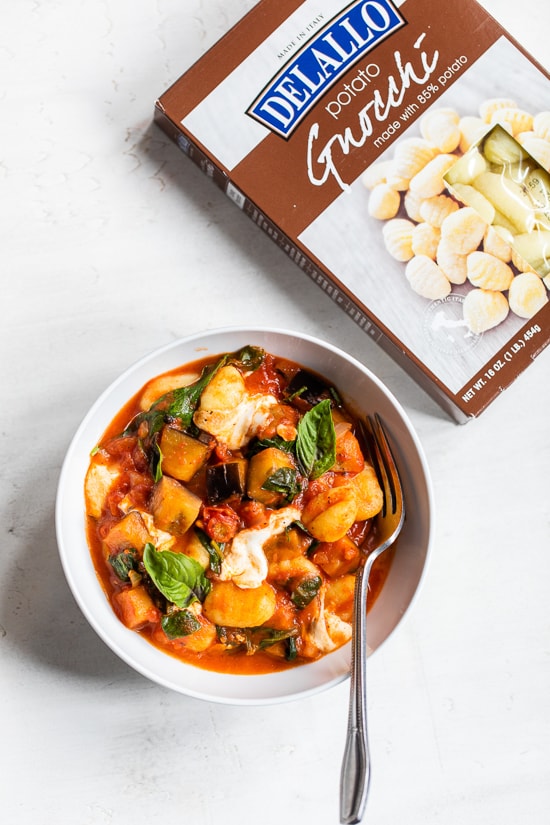 Eggplant with gnocchi sauce and mozzarella in a bowl.