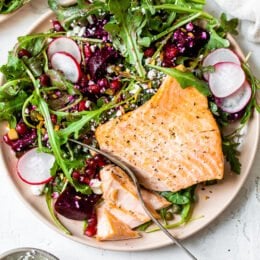 This beautiful heart-healthy salad makes salmon filets a focal point nestled atop the colorful salad with many textures.