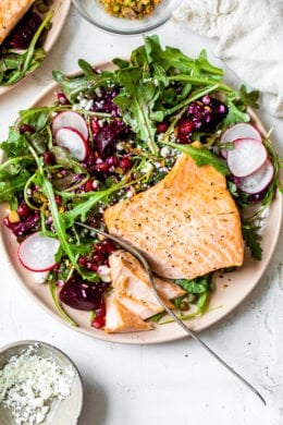 This beautiful heart-healthy salad makes salmon filets a focal point nestled atop the colorful salad with many textures.