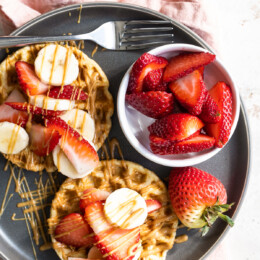 Waffles with strawberries, peanut butter and bananas.