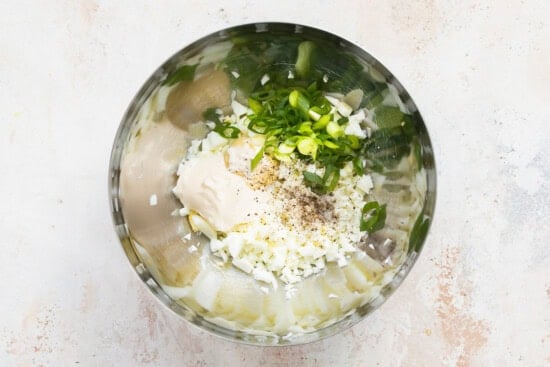 Eggs, mayo, scallions in a bowl.