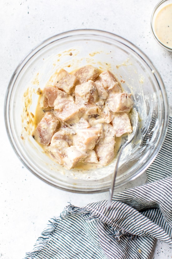 chicken breast marinating in Caesar dressing