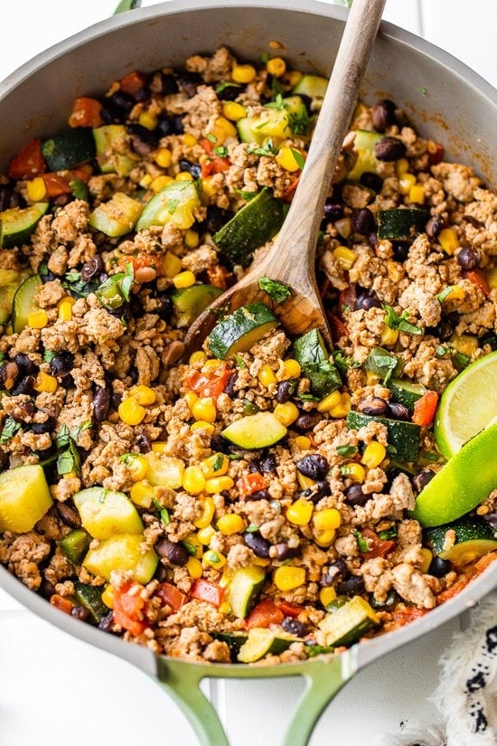 Ground Turkey with Zucchini, Corn, Black Beans and Tomatoes in a skillet.