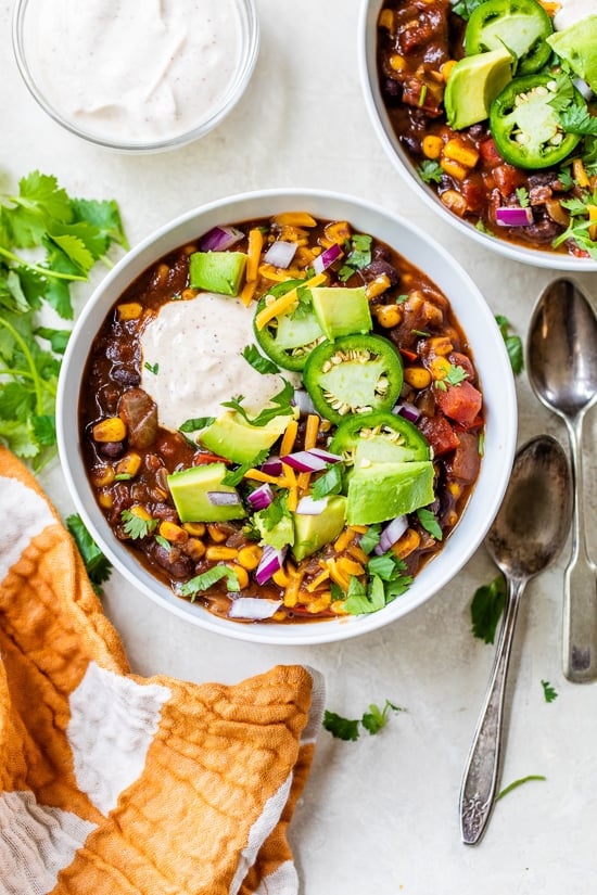 Black Bean Vegetarian Chili topped with yogurt, jalapenos, cheese and avocado.