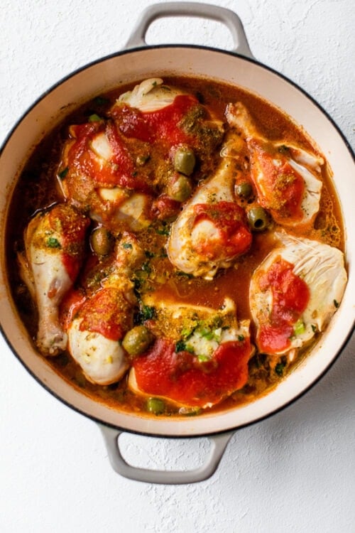 simmering chicken stew with tomato and olives