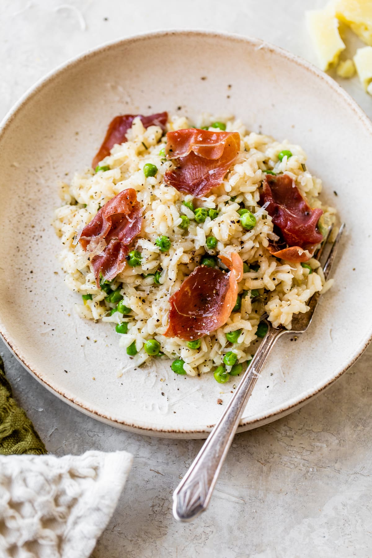 This Instant Pot Risotto recipe is the quickest, easiest way to make risotto. Perfectly creamy every time and it's ready in just 20 minutes. Overhead view of a bowl of Instant Pot risotto with prosciutto