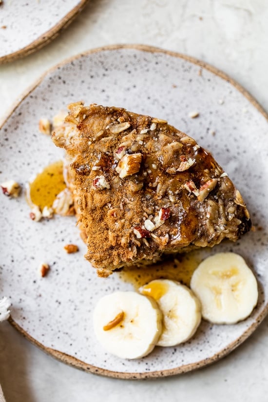 A baked oatmeal bar on a plate with banana slices