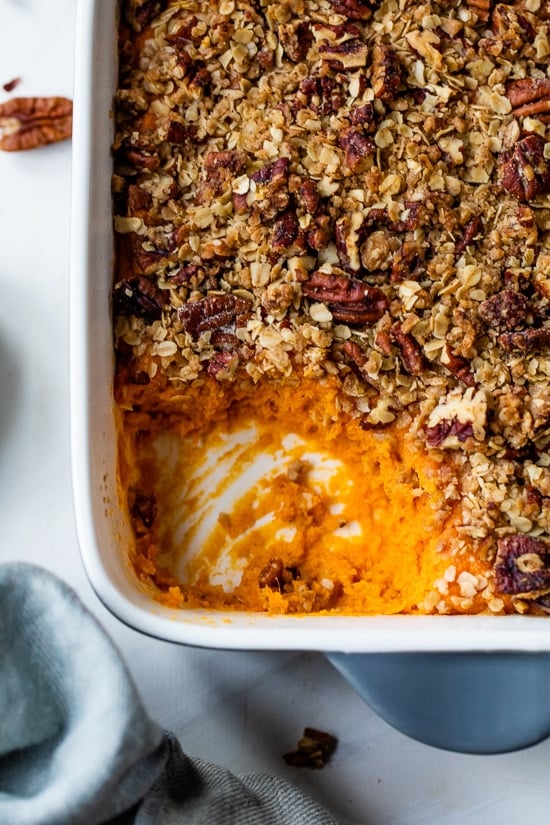 This lightened up Sweet Potato Casserole is made with roasted sweet potatoes and a praline topping for a crowd-pleasing Thanksgiving side! Vanilla Sweet Potato Casserole with Praline Topping