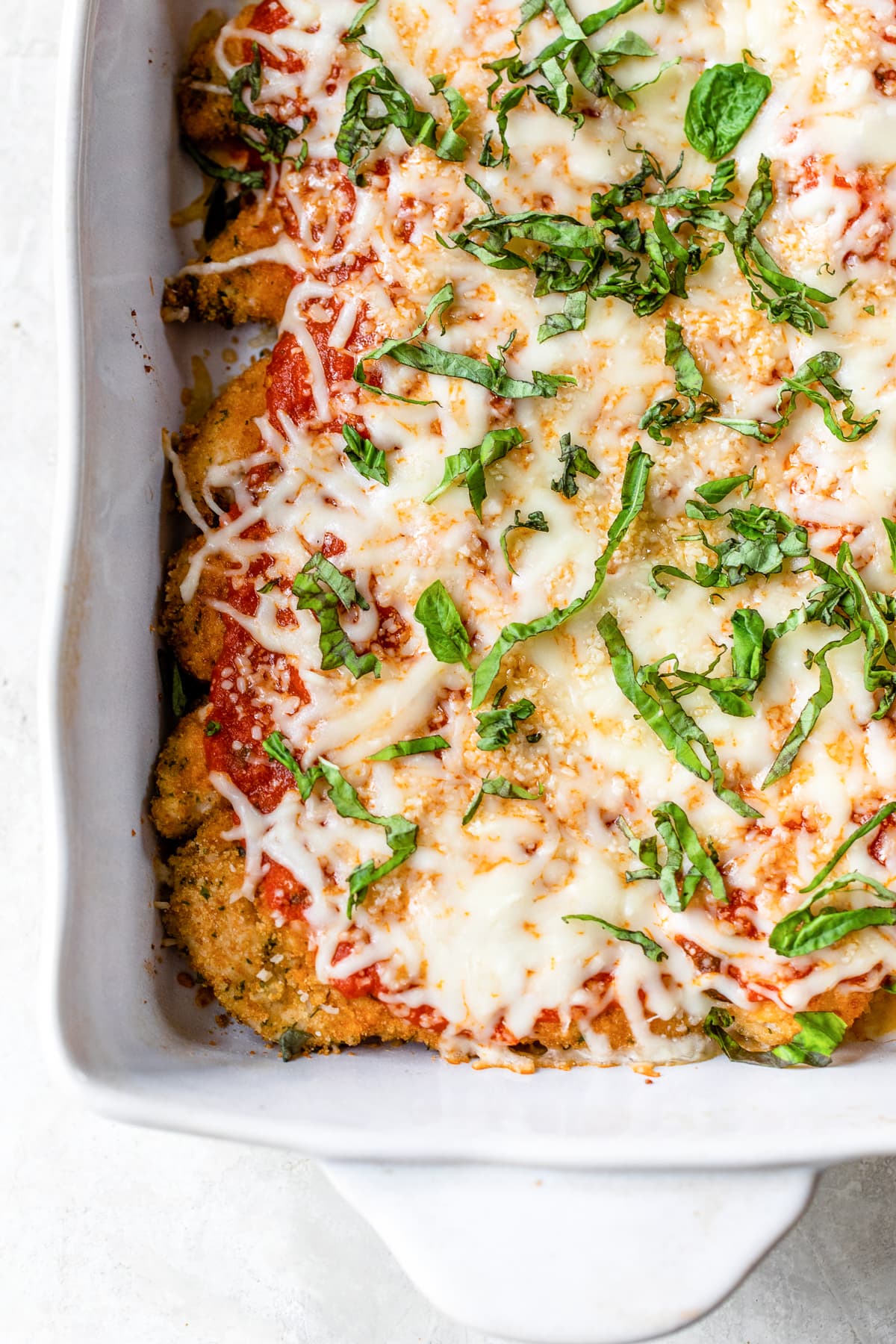 Quick and easy to prepare, this Baked Chicken Tenderloin Parmesan is a family-friendly weeknight dish, prepared with just a few ingredients. Baked Chicken tenderloin Parmesan in a baking dish