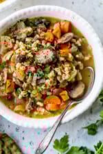 A bowl of Mushroom and Farro Soup with spoon