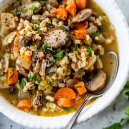 A bowl of Mushroom and Farro Soup with spoon