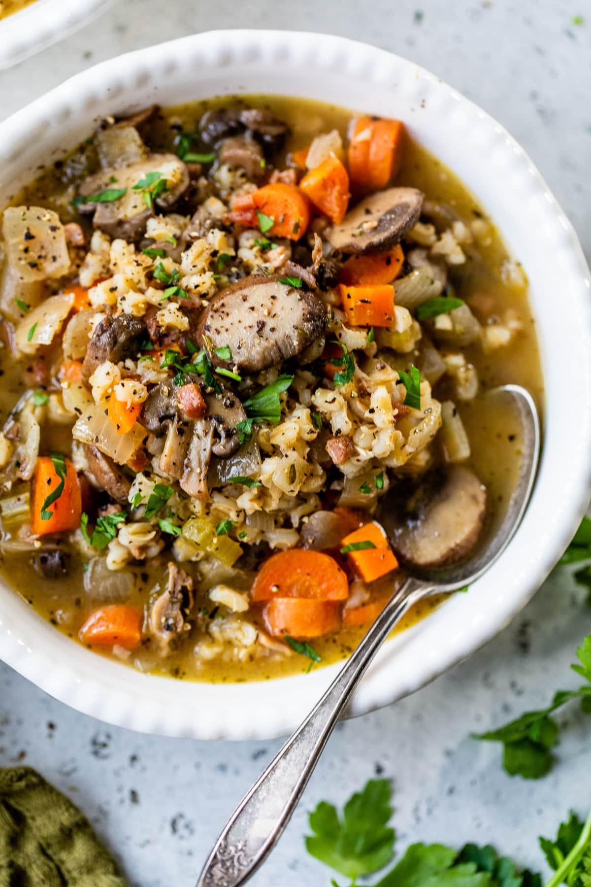 A bowl of Mushroom and Farro Soup with spoon