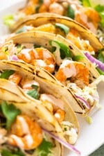 Spicy shrimp tacos topped with cabbage slaw and spicy cream sauce