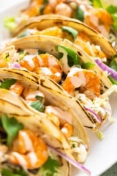 Spicy shrimp tacos topped with cabbage slaw and spicy cream sauce