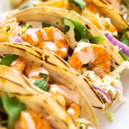 Spicy shrimp tacos topped with cabbage slaw and spicy cream sauce