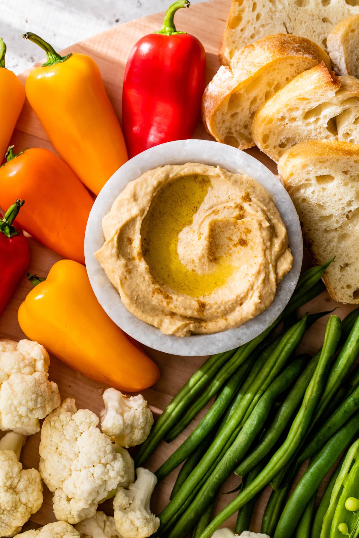 This modernized take on the veggie tray brings more visual appeal to the party staple. Like a vegetable charcuterie board with dips and more! hummus and veggies on board