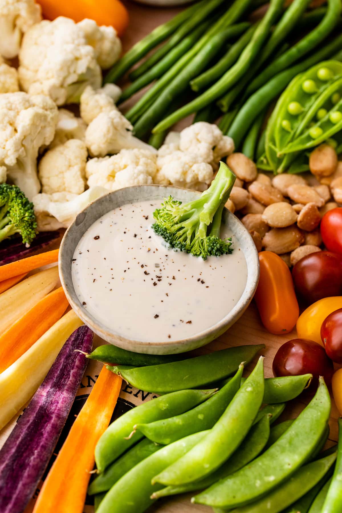This modernized take on the veggie tray brings more visual appeal to the party staple. Like a vegetable charcuterie board with dips and more! Broccoli floret in bowl of dip