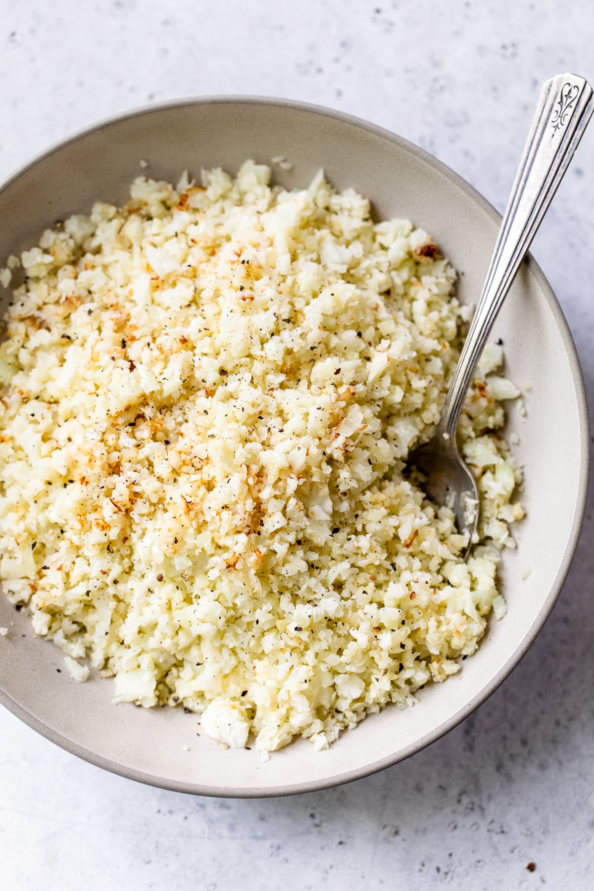 Here's a step-by-step recipe for making easy, low-carb cauliflower rice from scratch in the skillet or roasted in the oven. Riced Cauliflower