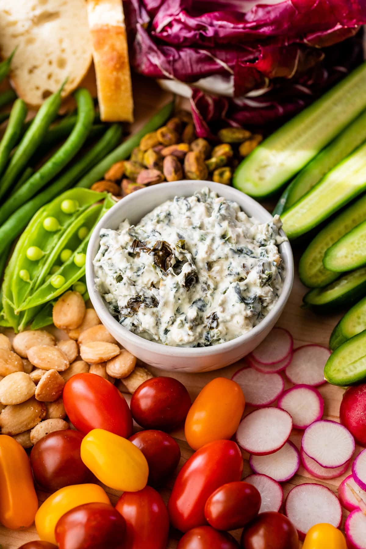 This modernized take on the veggie tray brings more visual appeal to the party staple. Like a vegetable charcuterie board with dips and more! Vegetables with spinach dip in bowl