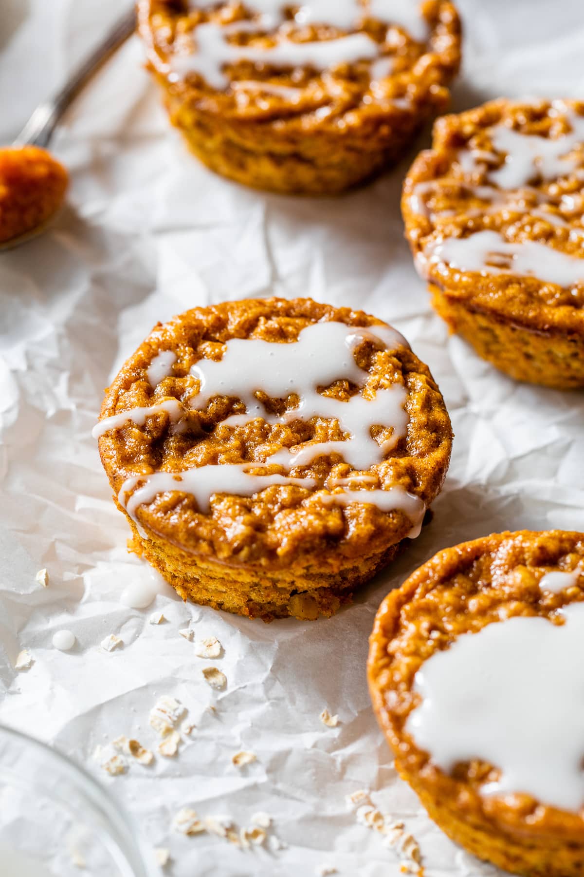 Made with pumpkin puree, oats, pumpkin pie spice, and yogurt, these Pumpkin Baked Oatmeal Cups are an easy breakfast full of fall flavor. Pumpkin Baked Oatmeal Cups drizzled with vanilla glaze