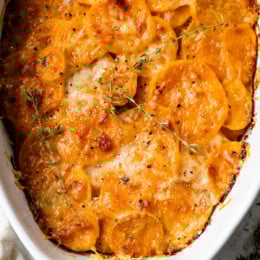 Overhead view of sweet potato gratin in an oval casserole dish.