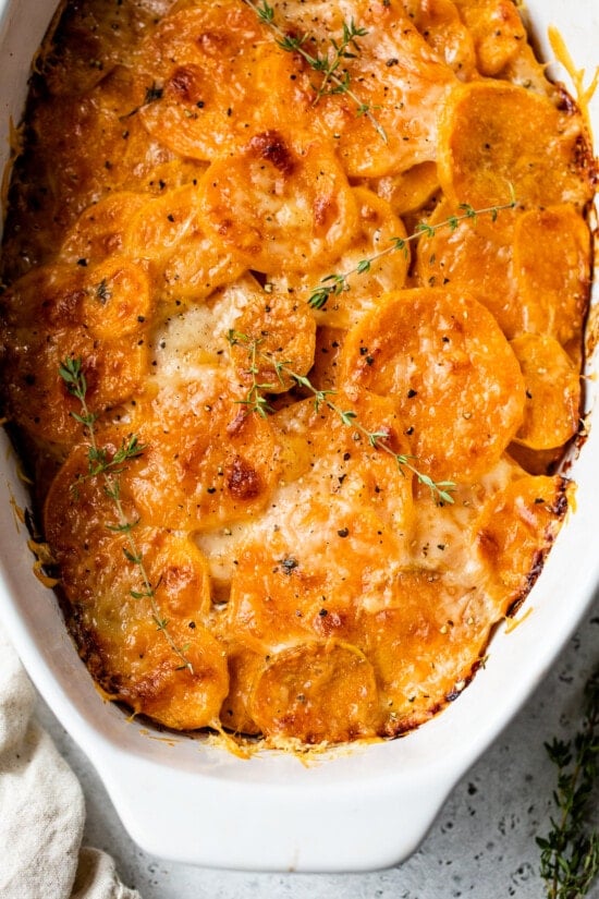 Overhead view of sweet potato gratin in an oval casserole dish.
