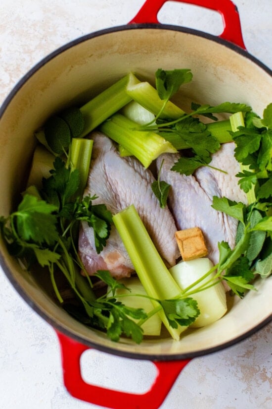 Made with just a handful of ingredients, this rich and flavorful Turkey Stock recipe is the secret to creating a memorable turkey gravy. Turkey Stock Ingredients in a Dutch Oven