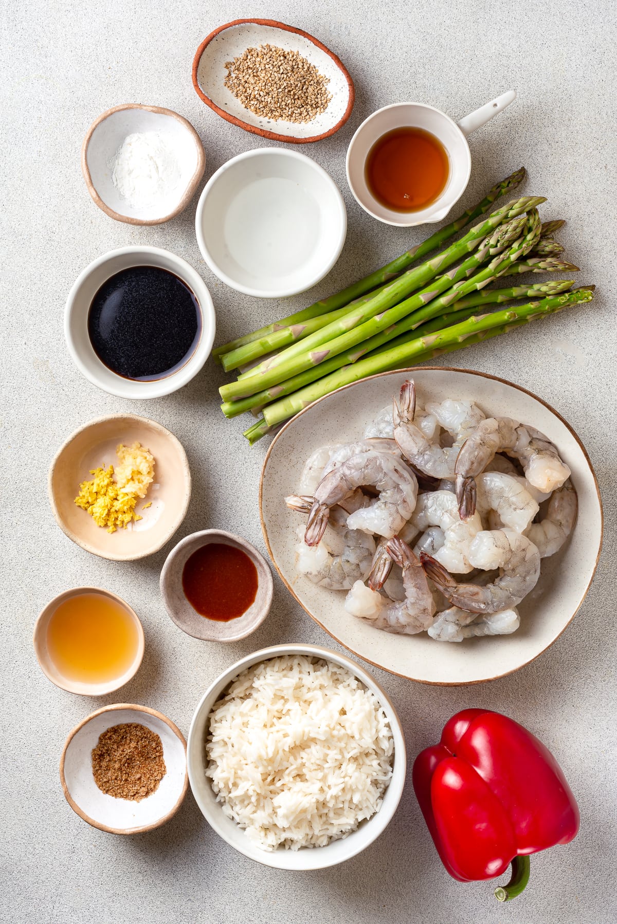 With juicy shrimp, asparagus, and red bell peppers, this Shrimp Stir Fry recipe makes a quick, easy, and healthy dinner in just 20 minutes! Overhead view of shrimp stir fry ingredients