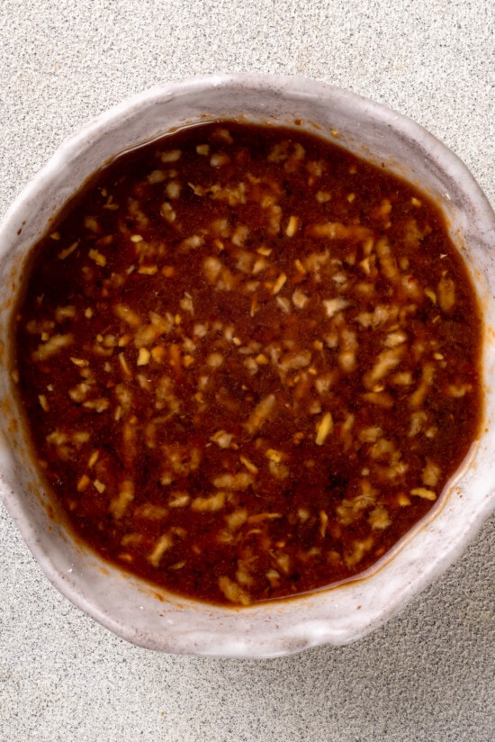 With juicy shrimp, asparagus, and red bell peppers, this Shrimp Stir Fry recipe makes a quick, easy, and healthy dinner in just 20 minutes! Stir fry sauce in a white bowl