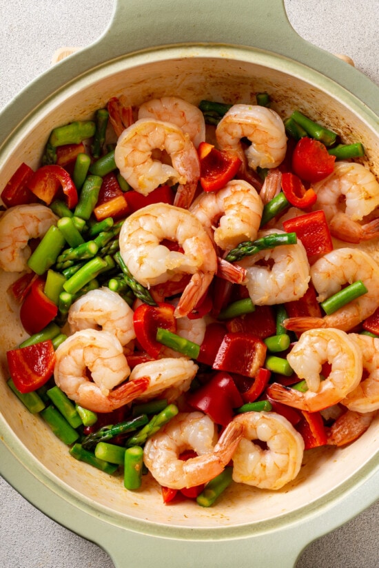 With juicy shrimp, asparagus, and red bell peppers, this Shrimp Stir Fry recipe makes a quick, easy, and healthy dinner in just 20 minutes! Shrimp, asparagus, and red bell peppers in a frying pan