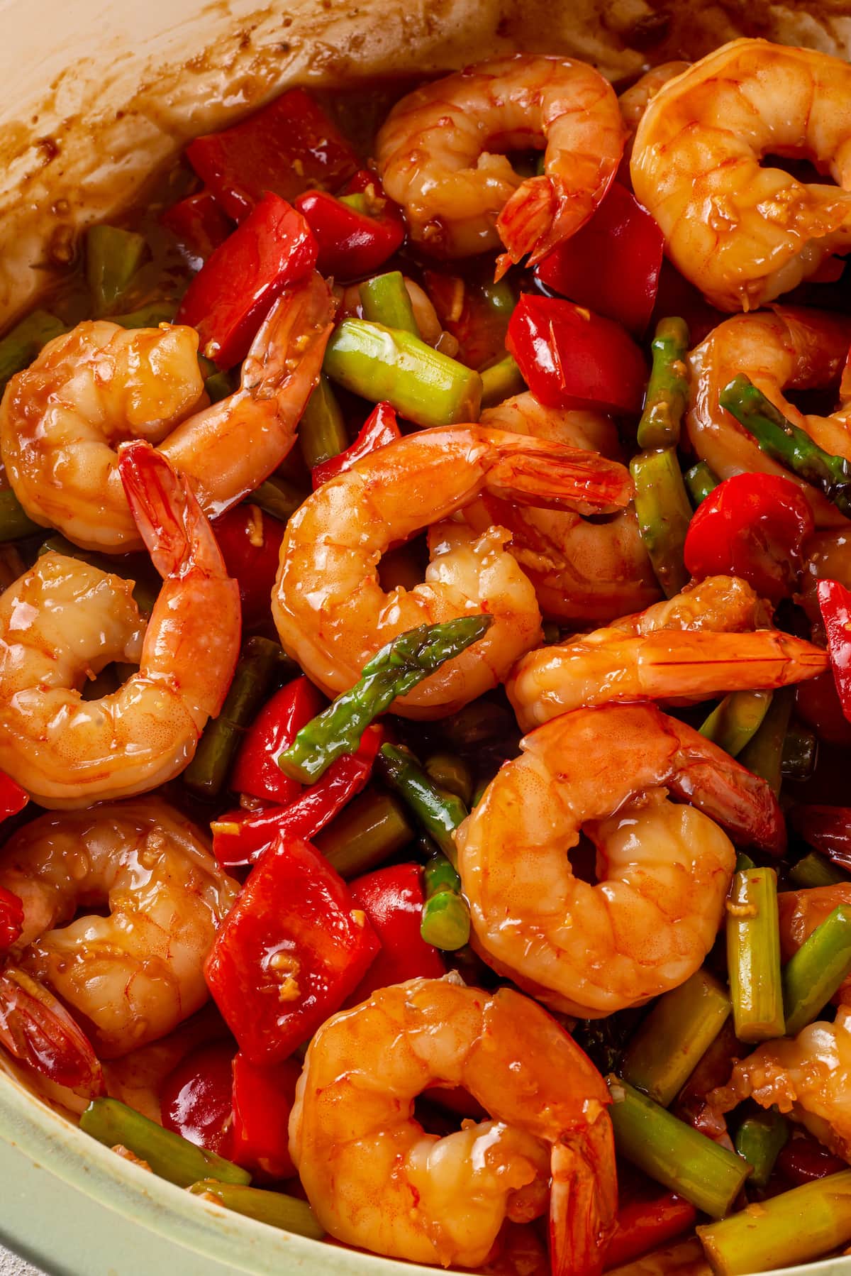 With juicy shrimp, asparagus, and red bell peppers, this Shrimp Stir Fry recipe makes a quick, easy, and healthy dinner in just 20 minutes! Close up of shrimp stir fry