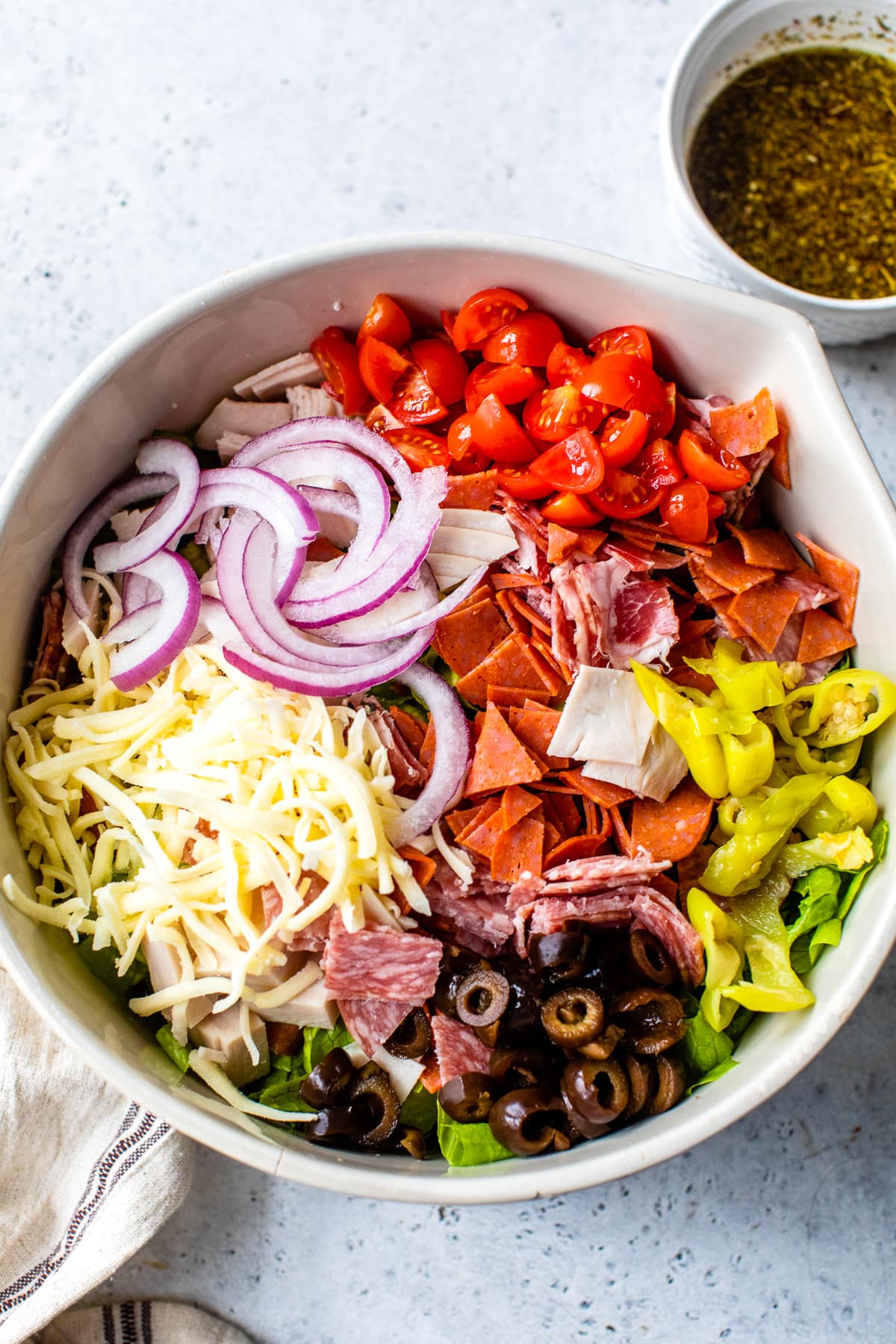 tomatoes, red onions, cheese, olives, salami, lettuce, banana peppers