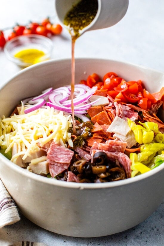 adding italian dressing to salad