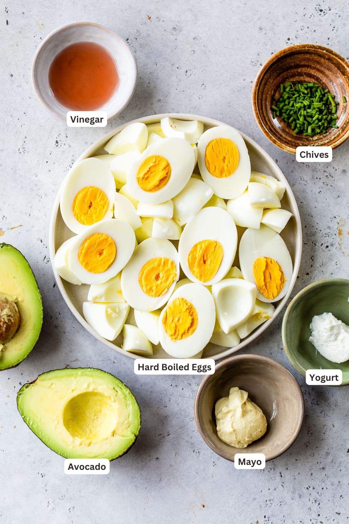 Ingredients for avocado egg salad in a bowl.