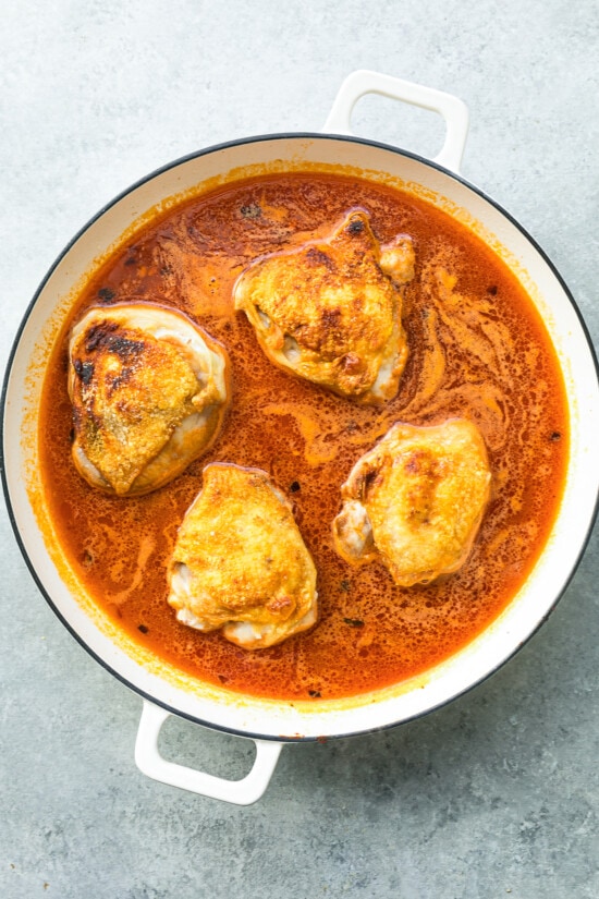add chicken thighs to the pot with orzo