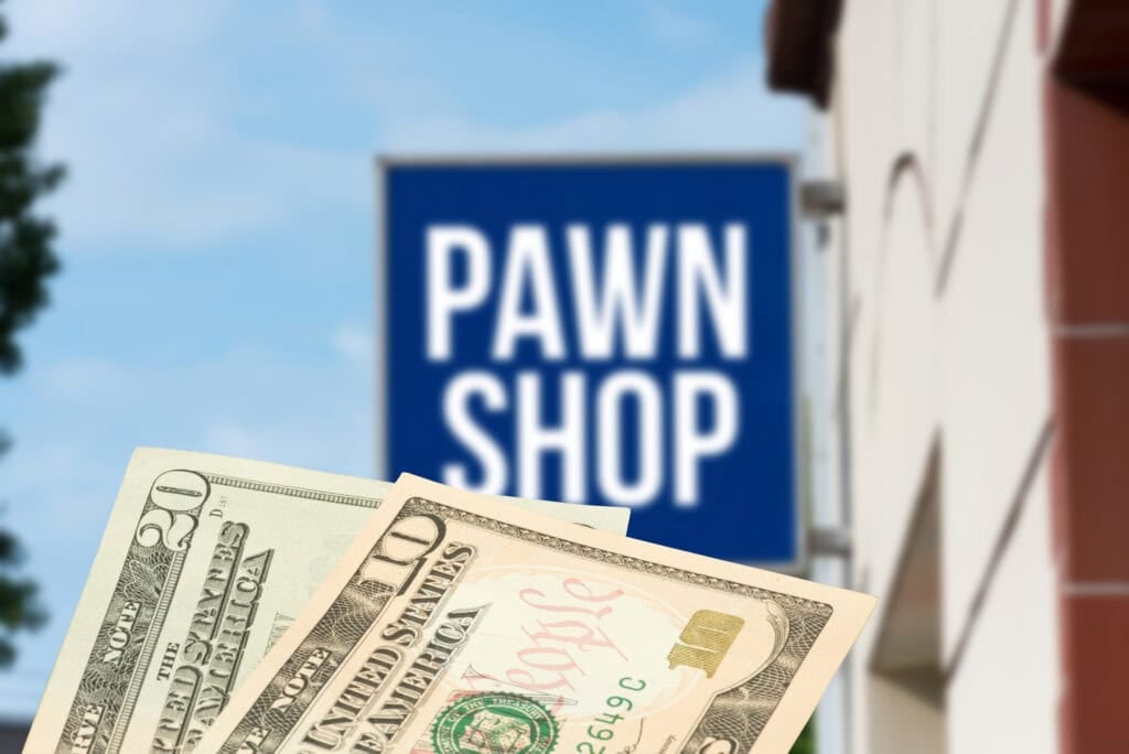 cash money in front of a pawn shop sign.
sell gold to pawn shop