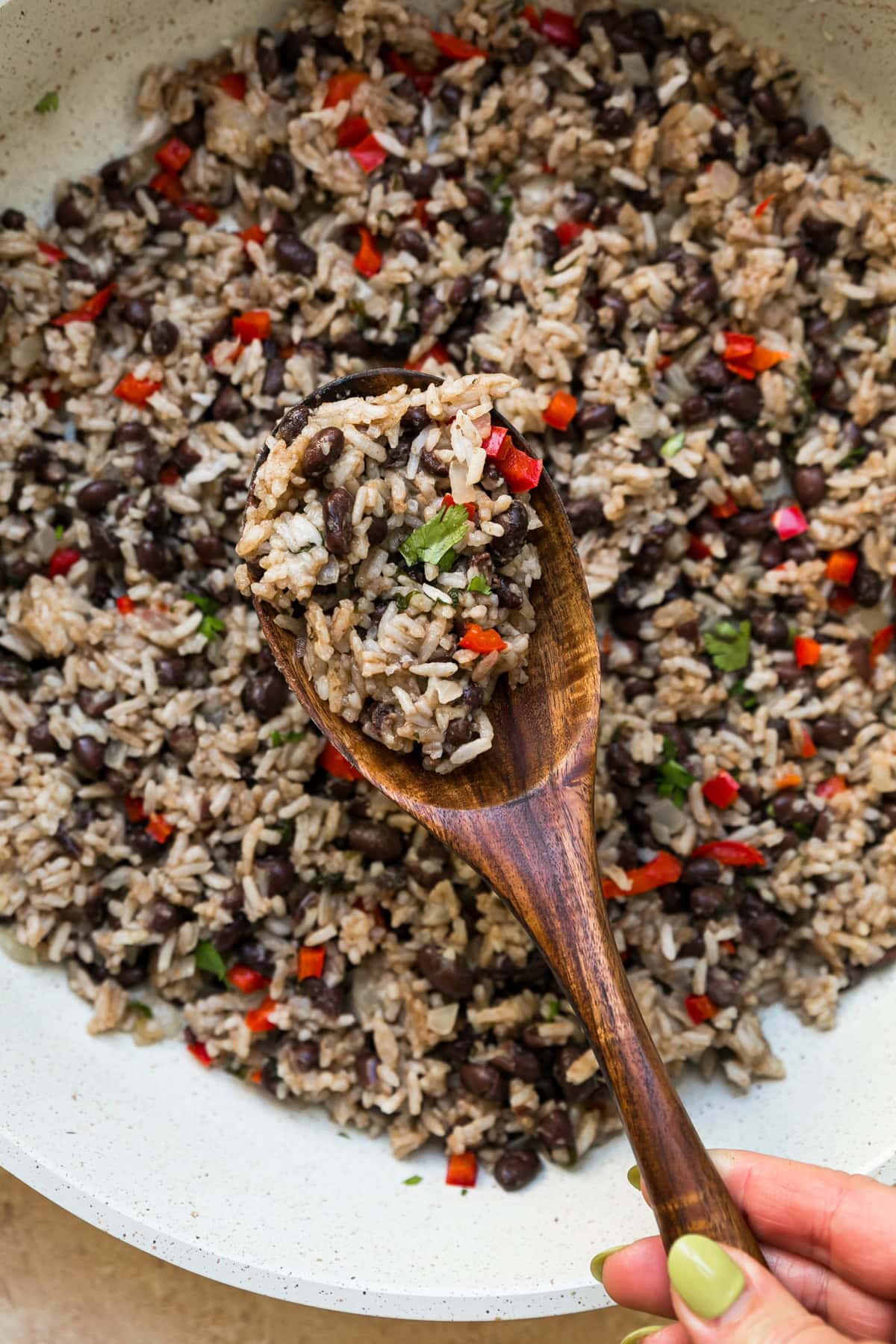 Gallo Pinto in a skillet with wooden spiooon