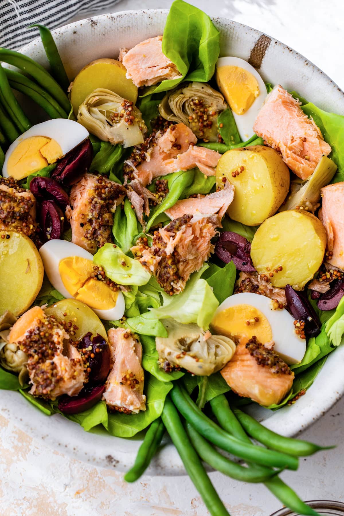 Salmon salad with hard boiled eggs, potatoes and green beans.