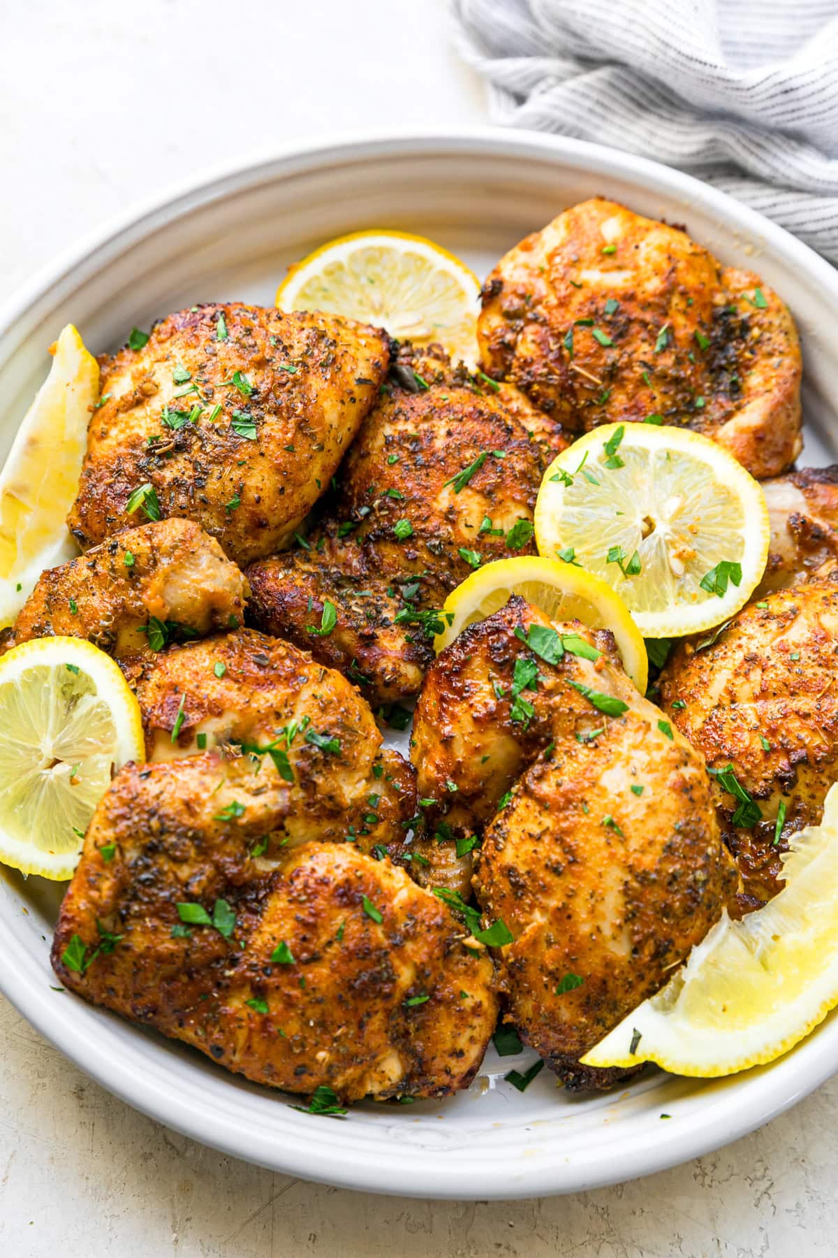 Chicken Thighs on a plate with lemon