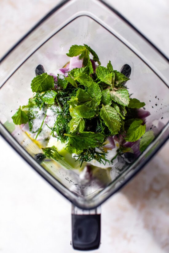 Place the yogurt, cucumbers and herbs in the blender.