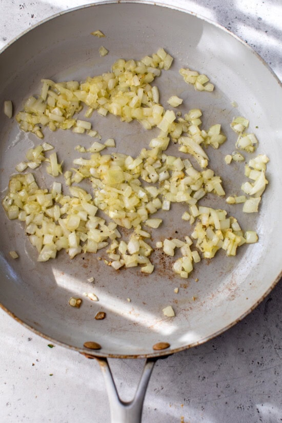 Onions cooking in a skillet.