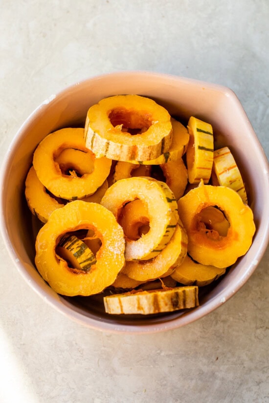 Remove seeds from the delicata squash and season.