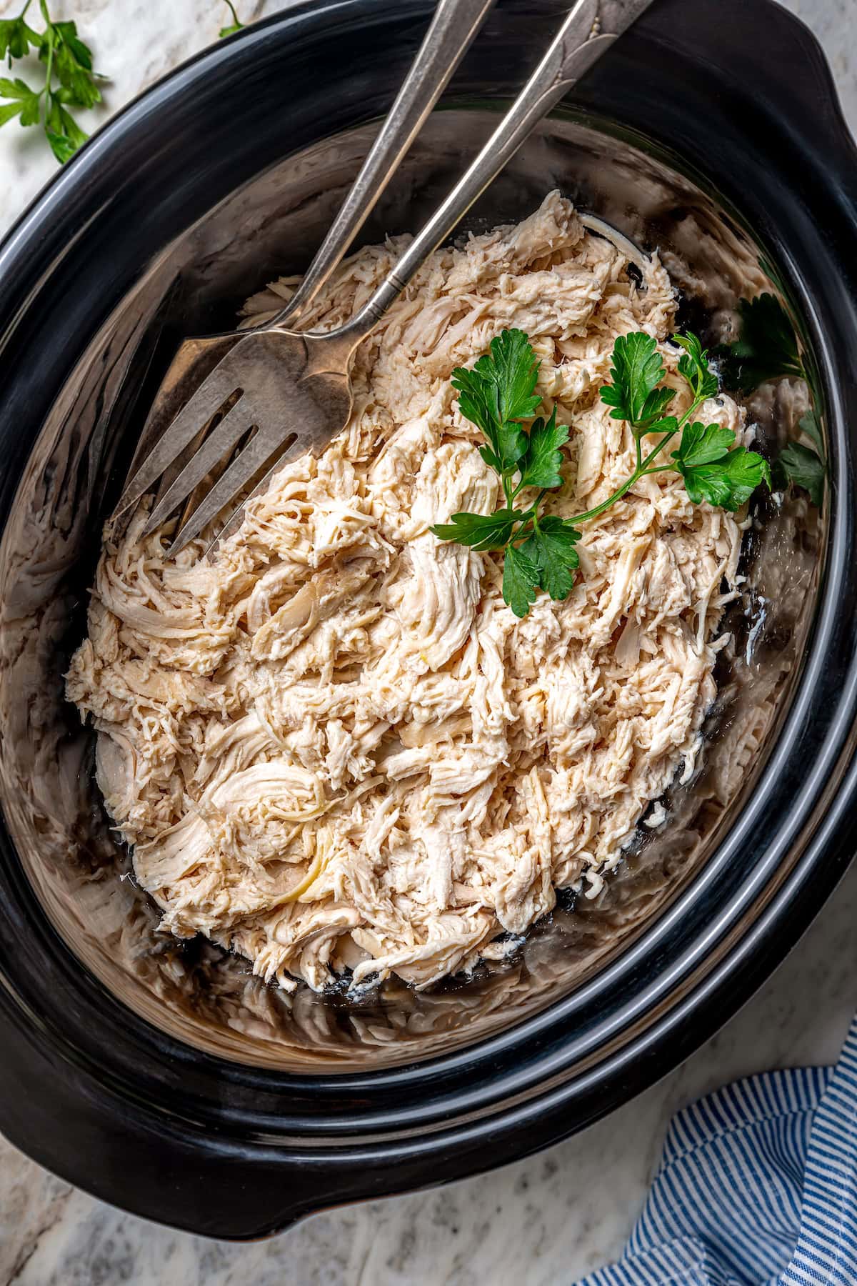 This slow cooker shredded chicken recipe is juicy, tender, and flavorful. It's a hands-off cooking method perfect for meal prep! Shredded chicken in slow cooker