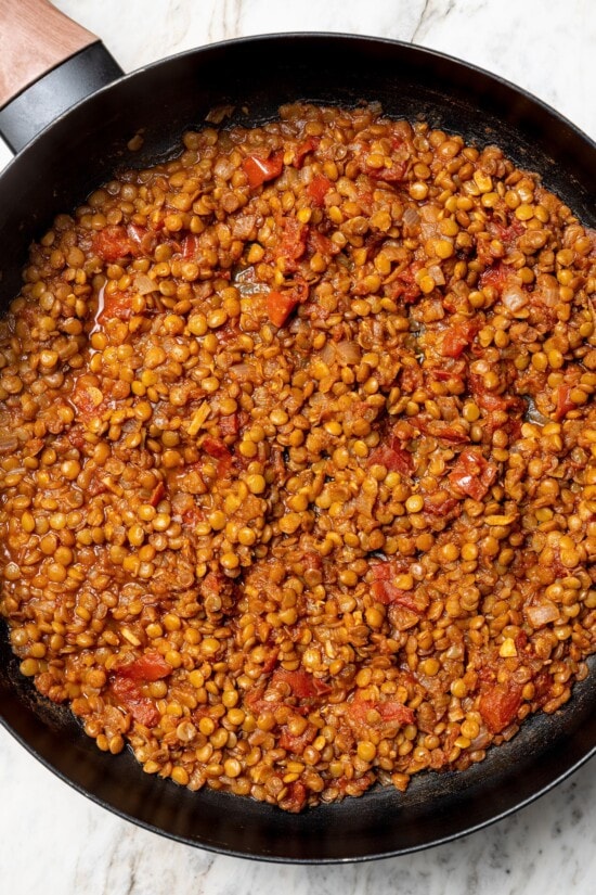 These vegan lentil tacos are easy to make, full of big Tex-Mex flavor and great for meal prep. Add your favorite toppings and dig in! Overhead view of lentils cooked in skillet