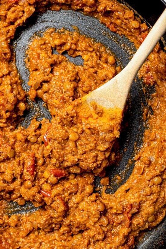 These vegan lentil tacos are easy to make, full of big Tex-Mex flavor and great for meal prep. Add your favorite toppings and dig in! Overhead view of lentil taco filling in skillet with wooden spoon